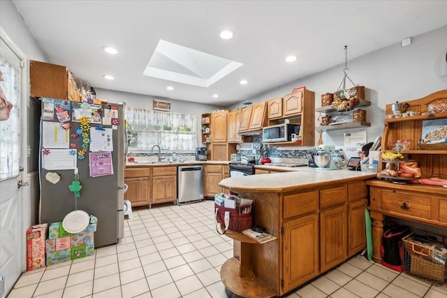 3363 Emeric Ave, Wantagh, NY 11793 - kitchen with open shelves, stainless steel appliances, a skylight, a sink, and light tile patterned floors