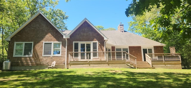 636 Hands Creek Rd, East Hampton, NY 11937 - back of house with a chimney, a lawn, a deck, and roof with shingles