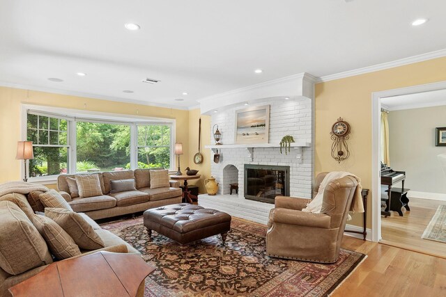 2 Shady Meadow Ln, Syosset, NY 11791 - living room featuring crown molding, light wood finished floors, a brick fireplace, recessed lighting, and baseboards