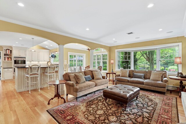 2 Shady Meadow Ln, Syosset, NY 11791 - living room featuring arched walkways, ornamental molding, light wood-type flooring, ornate columns, and recessed lighting