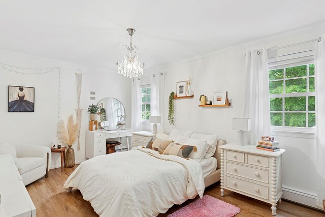 2 Shady Meadow Ln, Syosset, NY 11791 - bedroom featuring a baseboard radiator, a chandelier, wood finished floors, and ornamental molding