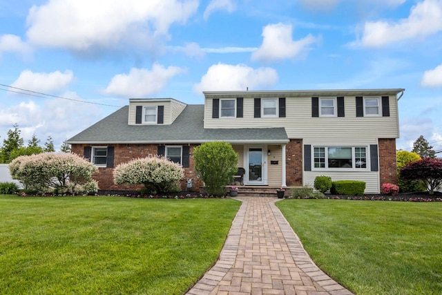 6 W Shore Rd, Bay Shore, NY 11706 - view of front of home with brick siding, a front lawn, and roof with shingles