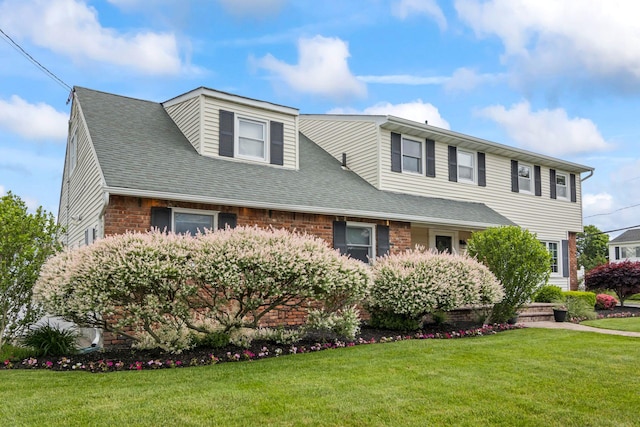 6 W Shore Rd, Bay Shore, NY 11706 - view of front facade with a front yard and roof with shingles
