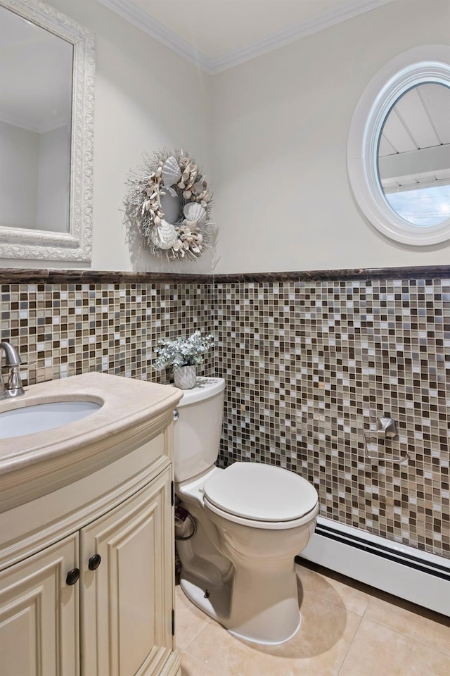6 W Shore Rd, Bay Shore, NY 11706 - half bathroom featuring a baseboard radiator, tile walls, tile patterned floors, toilet, and vanity