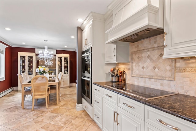 6 W Shore Rd, Bay Shore, NY 11706 - kitchen with custom range hood, black electric cooktop, stainless steel double oven, recessed lighting, and white cabinets