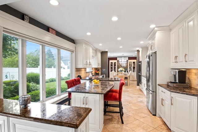 6 W Shore Rd, Bay Shore, NY 11706 - kitchen with a center island, plenty of natural light, recessed lighting, and white cabinets