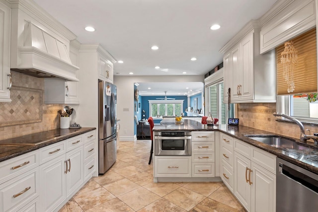 6 W Shore Rd, Bay Shore, NY 11706 - kitchen with stainless steel appliances, premium range hood, a sink, recessed lighting, and white cabinetry