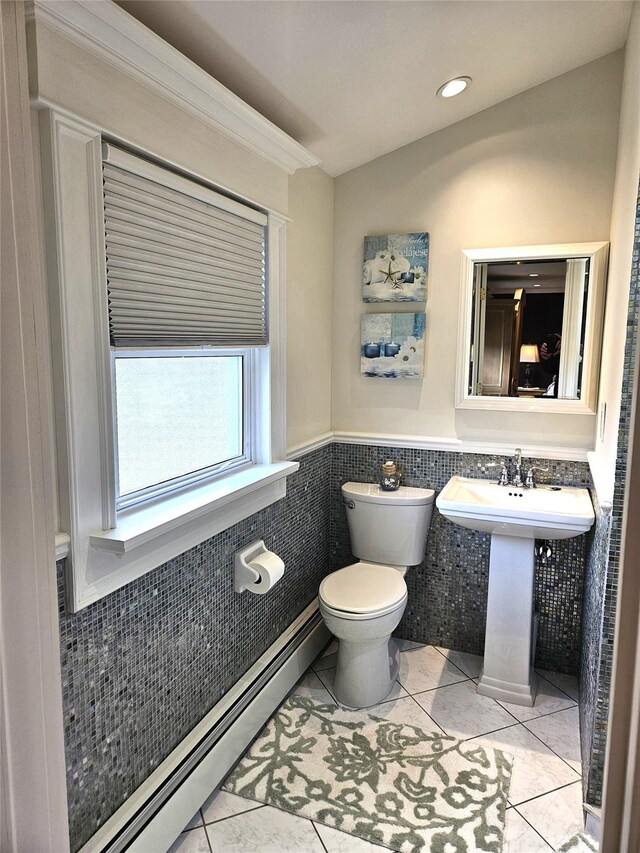 6 W Shore Rd, Bay Shore, NY 11706 - half bath featuring tile walls, toilet, a baseboard heating unit, tile patterned flooring, and wainscoting