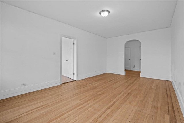20 William St Unit 3D, Mount Vernon, NY 10552 - spare room featuring arched walkways, light wood-style flooring, and baseboards