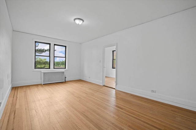 20 William St Unit 3D, Mount Vernon, NY 10552 - spare room with radiator heating unit, light wood-type flooring, and baseboards