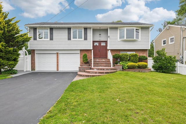 872 Main St, Farmingdale, NY 11735 - split foyer home featuring asphalt driveway, a garage, entry steps, and brick siding