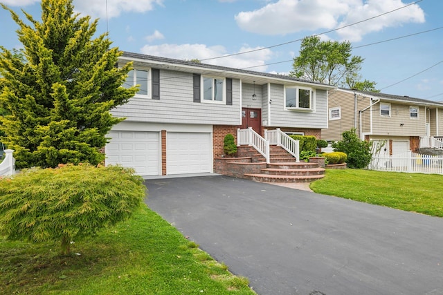 872 Main St, Farmingdale, NY 11735 - raised ranch featuring an attached garage and driveway