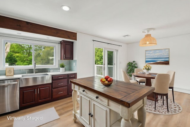 872 Main St, Farmingdale, NY 11735 - kitchen with dishwasher, a sink, butcher block countertops, light wood finished floors, and backsplash