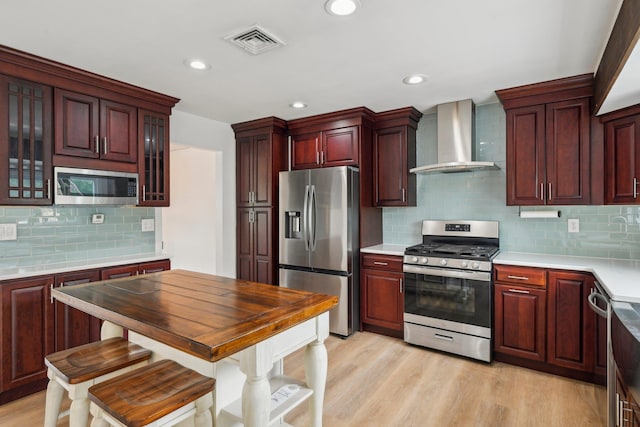 872 Main St, Farmingdale, NY 11735 - kitchen featuring stainless steel appliances, wall chimney range hood, backsplash, light countertops, and glass insert cabinets