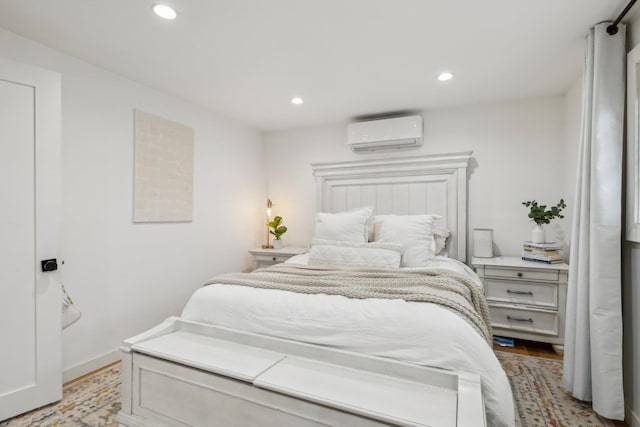 872 Main St, Farmingdale, NY 11735 - bedroom featuring a wall unit AC, recessed lighting, light wood-style flooring, and baseboards