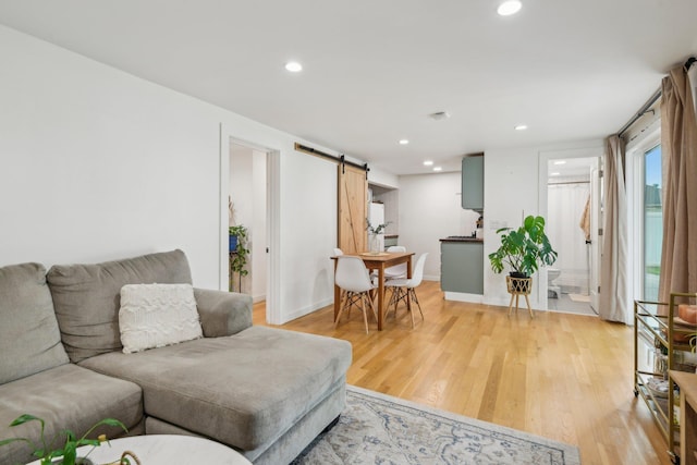 872 Main St, Farmingdale, NY 11735 - living area with a barn door, light wood-type flooring, recessed lighting, and baseboards