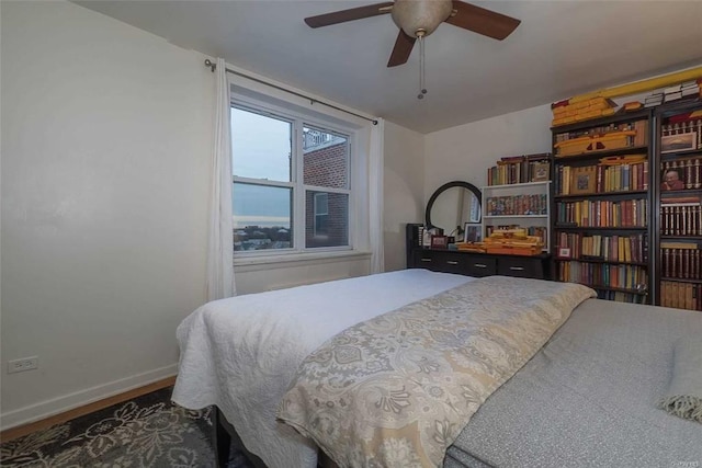 84-50 169th St Unit 606, Jamaica Hills, NY 11432 - bedroom featuring baseboards, wood finished floors, and a ceiling fan