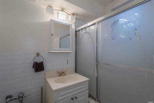 84-50 169th St Unit 606, Jamaica Hills, NY 11432 - full bath with vanity, a shower with door, tile walls, and tasteful backsplash
