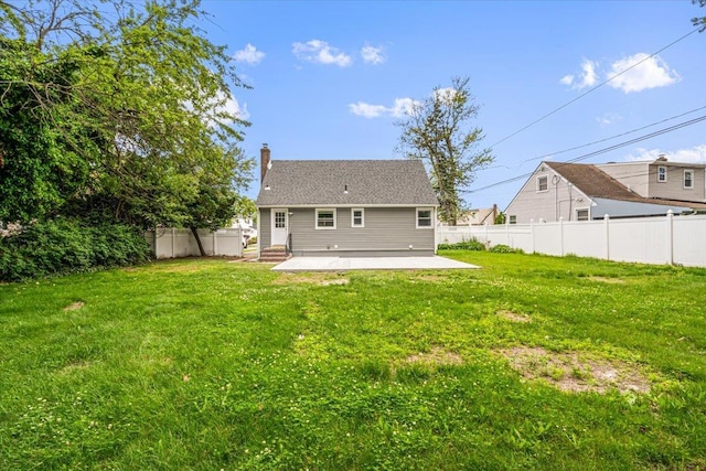 855 Winter Ave, Uniondale, NY 11553 - back of house featuring a patio, a chimney, and entry steps