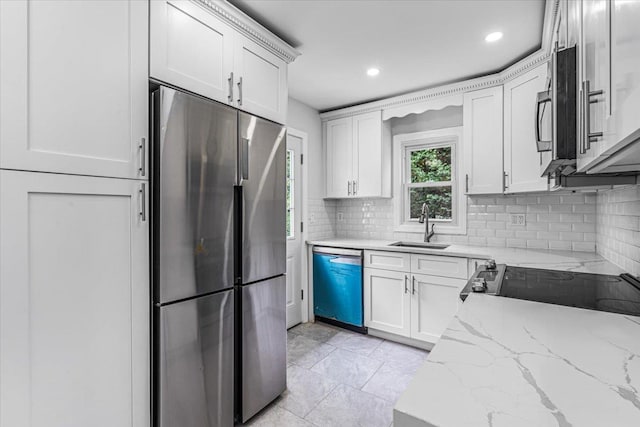 855 Winter Ave, Uniondale, NY 11553 - kitchen featuring appliances with stainless steel finishes, a sink, tasteful backsplash, white cabinetry, and recessed lighting