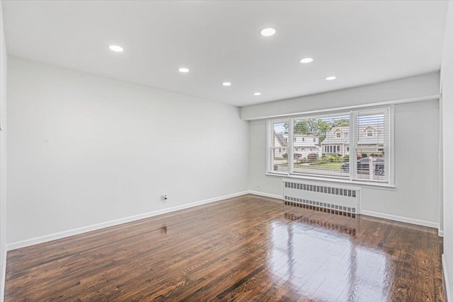 855 Winter Ave, Uniondale, NY 11553 - empty room with radiator heating unit, recessed lighting, baseboards, and wood finished floors
