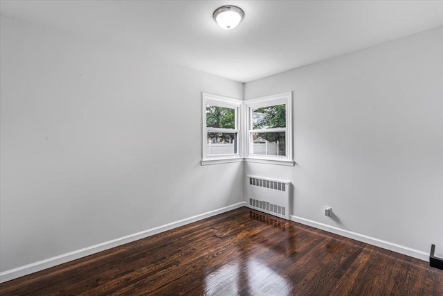 855 Winter Ave, Uniondale, NY 11553 - empty room featuring radiator, wood finished floors, and baseboards