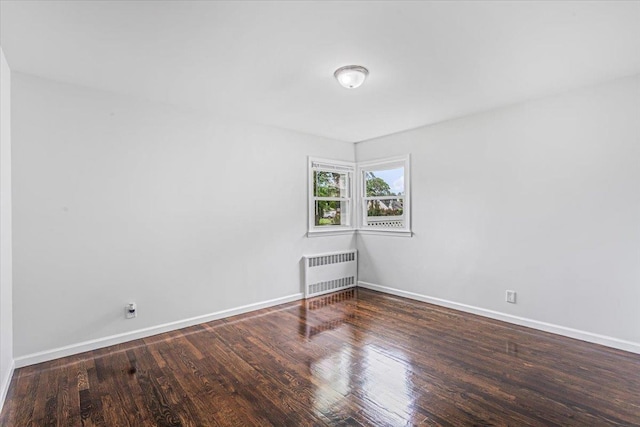 855 Winter Ave, Uniondale, NY 11553 - unfurnished room featuring radiator, wood finished floors, and baseboards
