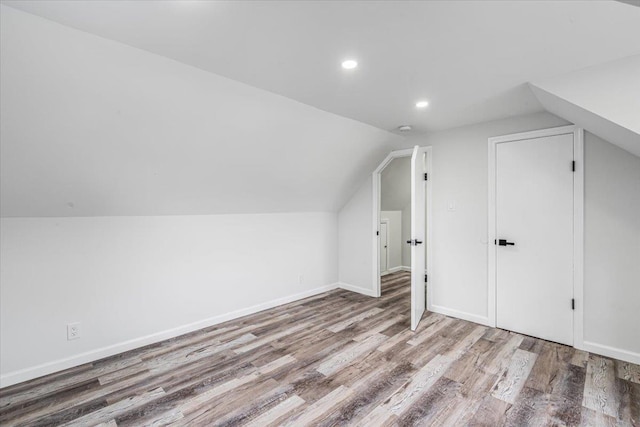 855 Winter Ave, Uniondale, NY 11553 - additional living space featuring wood finished floors, vaulted ceiling, recessed lighting, and baseboards