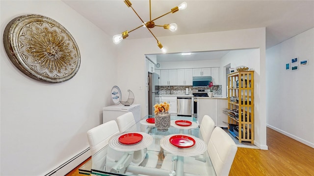 37-40 61st St, Woodside, NY 11377 - dining room with light wood finished floors, a chandelier, and a baseboard heating unit