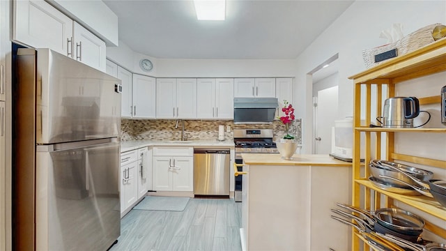 37-40 61st St, Woodside, NY 11377 - kitchen featuring appliances with stainless steel finishes, tasteful backsplash, white cabinetry, butcher block countertops, and light wood-style floors