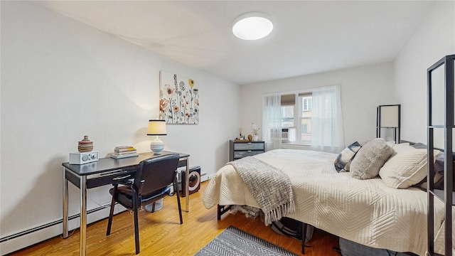 37-40 61st St, Woodside, NY 11377 - bedroom featuring wood finished floors and baseboard heating