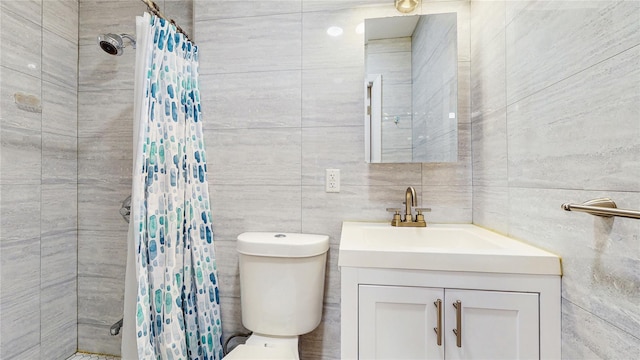 37-40 61st St, Woodside, NY 11377 - bathroom featuring vanity, tiled shower, and tile walls