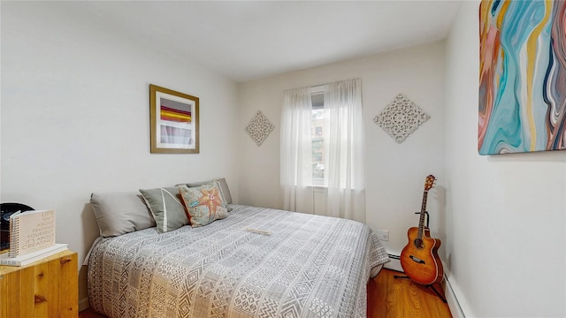 37-40 61st St, Woodside, NY 11377 - bedroom featuring wood finished floors and baseboard heating