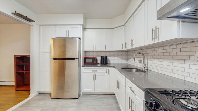 37-40 61st St, Woodside, NY 11377 - kitchen featuring black appliances, extractor fan, a baseboard heating unit, white cabinetry, and tasteful backsplash