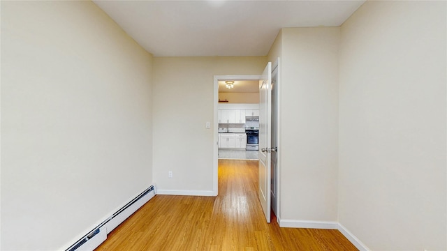 37-40 61st St, Woodside, NY 11377 - hall with baseboard heating and light wood-style floors