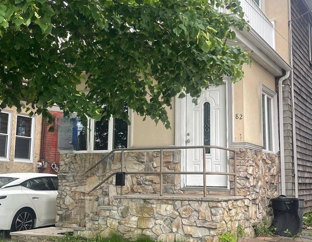 82 Bch 2nd St, Lawrence, NY 11559 - view of home's exterior featuring stone siding and stucco siding