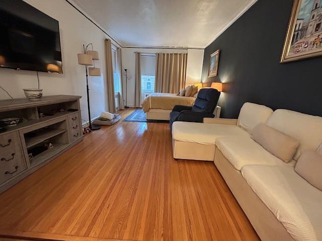 86-10 34th Ave Unit 624, Jackson Heights, NY 11372 - living area with light wood-style floors and ornamental molding
