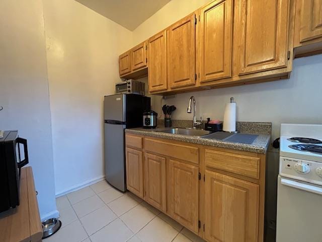 86-10 34th Ave Unit 624, Jackson Heights, NY 11372 - kitchen with white electric range, freestanding refrigerator, dark countertops, a sink, and light tile patterned flooring