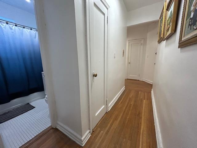 86-10 34th Ave Unit 624, Jackson Heights, NY 11372 - corridor featuring wood finished floors and baseboards