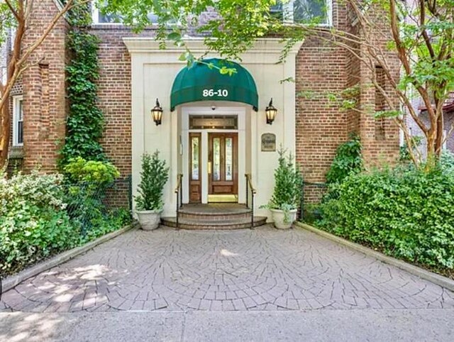86-10 34th Ave Unit 624, Jackson Heights, NY 11372 - view of exterior entry with brick siding