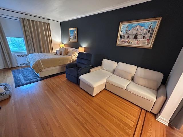 86-10 34th Ave Unit 624, Jackson Heights, NY 11372 - bedroom with radiator and wood finished floors