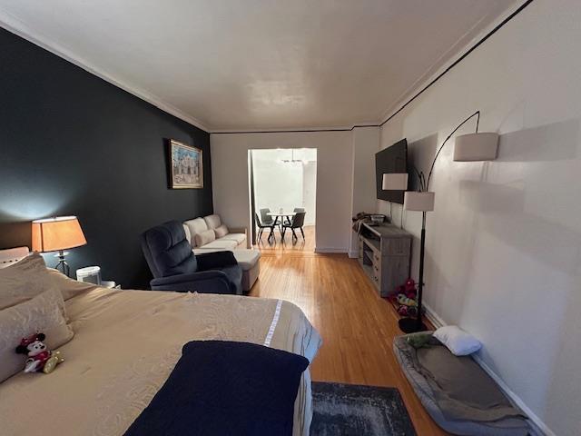 86-10 34th Ave Unit 624, Jackson Heights, NY 11372 - bedroom with light wood-style floors and crown molding