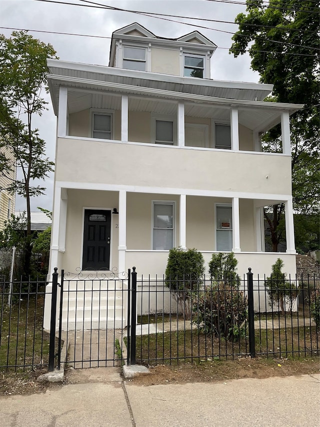 234 S 3rd Ave, Mount Vernon, NY 10550 - view of front of home with covered porch, a balcony, and stucco siding