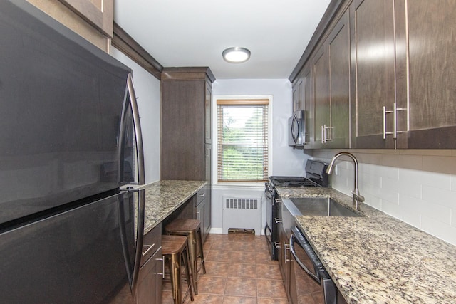 251-10 71st Rd Unit 30A, Bellerose, NY 11426 - kitchen featuring freestanding refrigerator, a sink, radiator, range with gas cooktop, and light stone counters