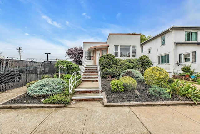 5 E Walnut St, Long Beach, NY 11561 - view of front of home with stucco siding and stairs