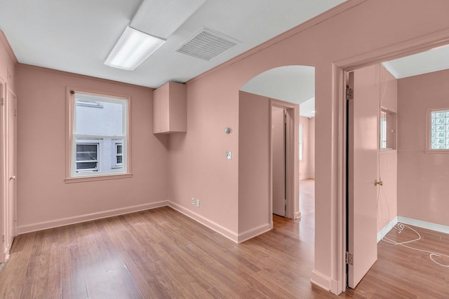 5 E Walnut St, Long Beach, NY 11561 - unfurnished room with baseboards, light wood-style flooring, arched walkways, and crown molding