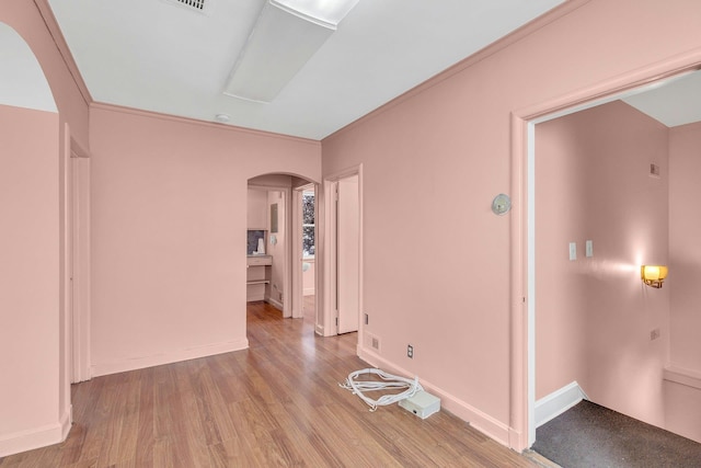 5 E Walnut St, Long Beach, NY 11561 - spare room featuring arched walkways, wood finished floors, crown molding, and baseboards