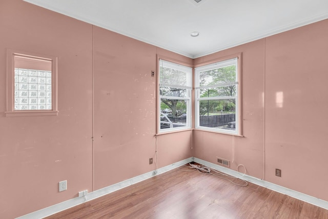 5 E Walnut St, Long Beach, NY 11561 - empty room featuring wood finished floors, baseboards, and ornamental molding