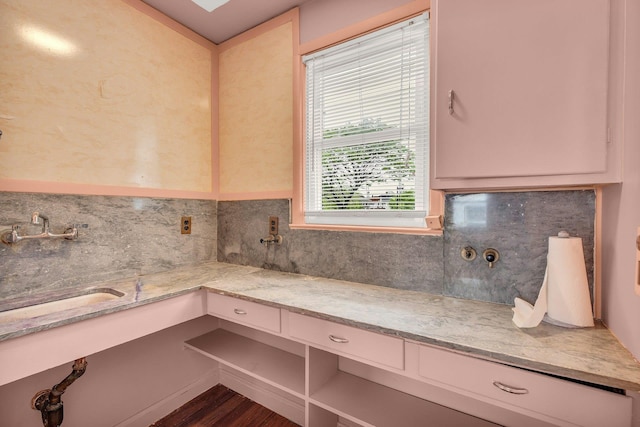 5 E Walnut St, Long Beach, NY 11561 - kitchen with decorative backsplash, light stone countertops, and a sink