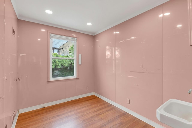 5 E Walnut St, Long Beach, NY 11561 - spare room featuring light wood finished floors, a sink, baseboards, crown molding, and recessed lighting